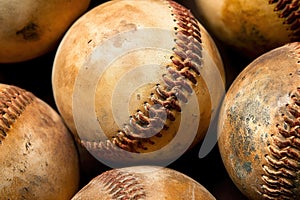 The weathered and coarse surface of antique baseballs on green background