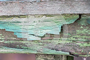 Weathered and cracked paint on a wooden fence