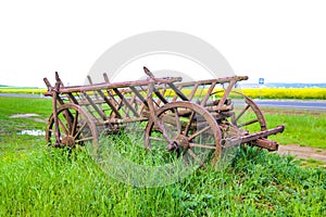 Weathered cracked wood wheel spokes surface texture. Antique wooden wheel van closeup. Traditional rural transport. Historic sites