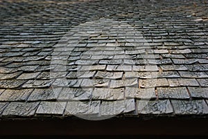 Weathered dark texture of wooden tile roof
