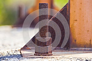 Weathered and decaying metal framework with rust-encrusted bolts