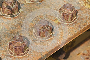 Weathered and decaying metal framework with rust-encrusted bolts and nuts - Old rusty iron structure