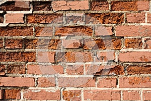 Weathered destruction of ancient brick building wall.