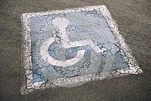 Weathered Disabled Sign in Parking Lot