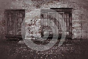 Weathered doors in grungy shot of a ruined facade