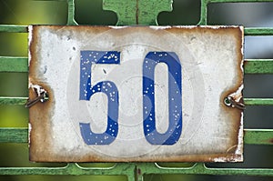 Weathered enameled plate number 50