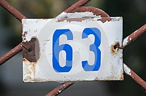 Weathered enameled plate number 63