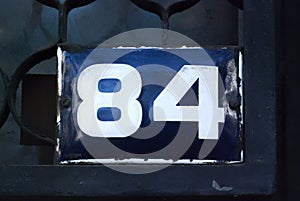 Weathered enameled plate number 84