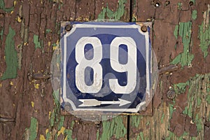 Weathered enameled plate number 89
