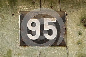 Weathered enameled plate number 95