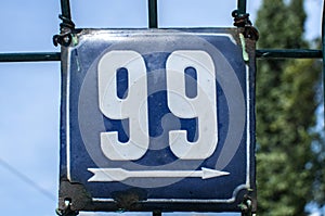 Weathered enameled plate number 99