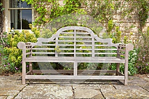 Weathered garden bench in landscaped setting