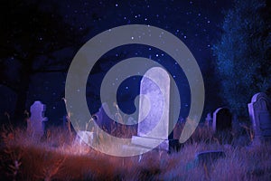 Weathered gravestone standing in an old abandoned cemetery among dry autumn grass at night. Generative AI