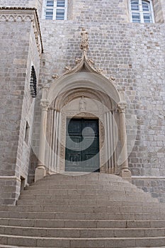 The weathered green door marks the entrance to the Dominican Monastery