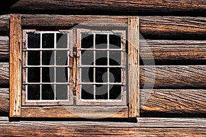 Weathered log house wall window
