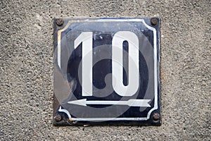 Weathered metal enameled plate of street address number 10