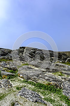 Weathered Mountain Hillside With Rocky Outcrops And Grass