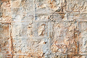 A weathered natural sandstone brick wall