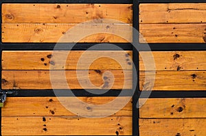 Weathered old barn wood door with vintage iron hinges on an anti