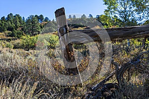 A weathered old fence edges an autumn meadow on Pinon Mesa, Colorado