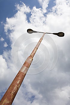 Weathered old streetlamps against cloudy sky