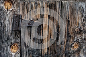 Old barn wood plank door and rusty hinge