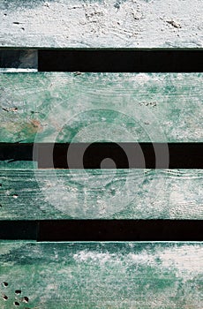 Weathered old wood faded green painted background