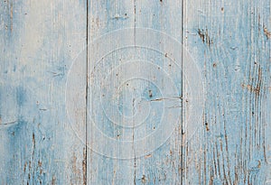 Weathered paint of old rustic light blue wood wall background texture
