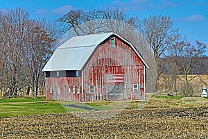 Weathered Red Wood Barn with a Flag