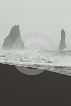 Weathered rocks on beach monochrome landscape photo
