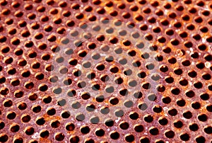 Weathered rusty metal surface with holes and blur effect