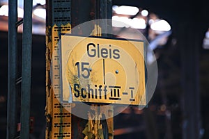 Weathered sign in a railroad workshop with the German words Gleis 15 Schiff III-I (track 15 aisle III-I)
