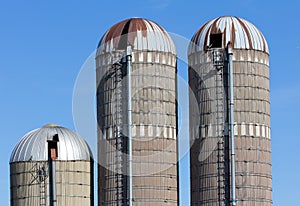 Weathered silos against blue sky in rural United States