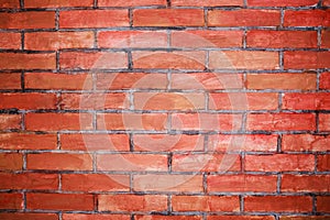 Weathered stained old brick wall with cracks and scratches. Brickwork