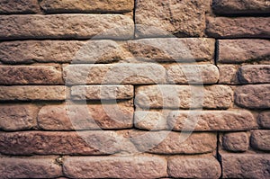 Weathered texture of stained old brown brick wall background.