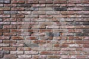 Weathered texture of stained old dark brown and red brick wall background, grungy rusty blocks of stone-work technology, colorful