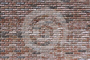 Weathered texture of stained old dark brown and red brick wall background, grungy rusty blocks of stone-work technology, colorful