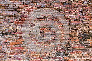 Weathered texture of stained old dark brown and red brick wall t