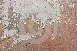 Weathered tinny surface with damages and rust. Abstract detailed texture. An old wall background painted red.