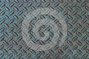 Weathered treadplate background with blue-green patina