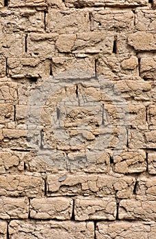 Weathered wall of a house built of bricks from clay.