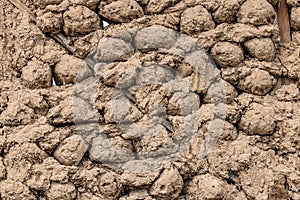 Rustic mud and stick balls wall in rural outdoor setting