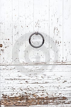 Weathered white wooden door with paint chipped and peeling.