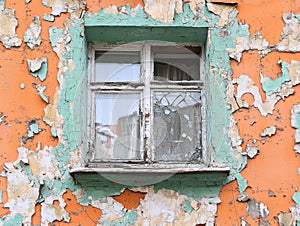 Weathered Window with Peeling Paint on Orange Wall