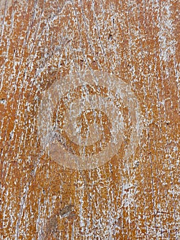 Weathered wood background with peeling orange paint