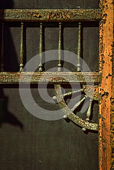 Weathered wood screen door detail on porch steps of Victorian house
