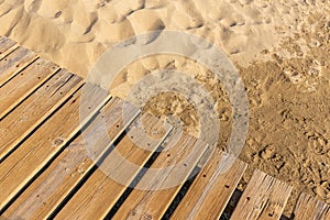 Weathered wooden boardwalk on sand