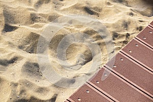 Weathered wooden boardwalk on sand dune