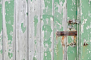 Weathered wooden door peeling green paint