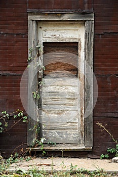 Weathered wooden door on red wall